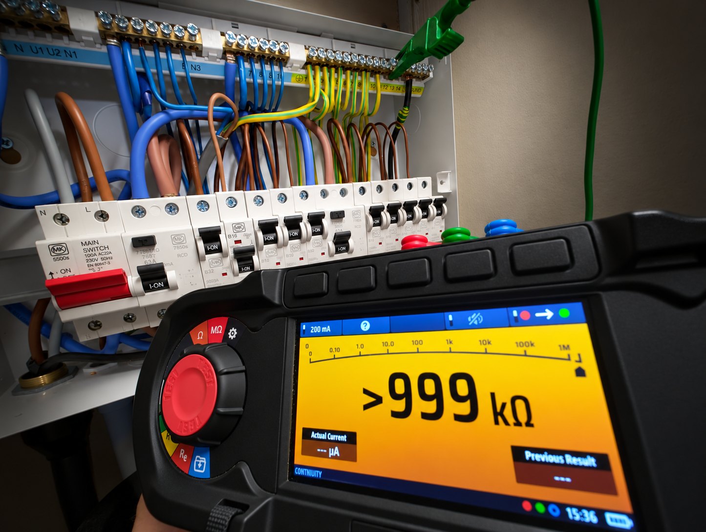 Electrician inspecting a consumer unit by head torch