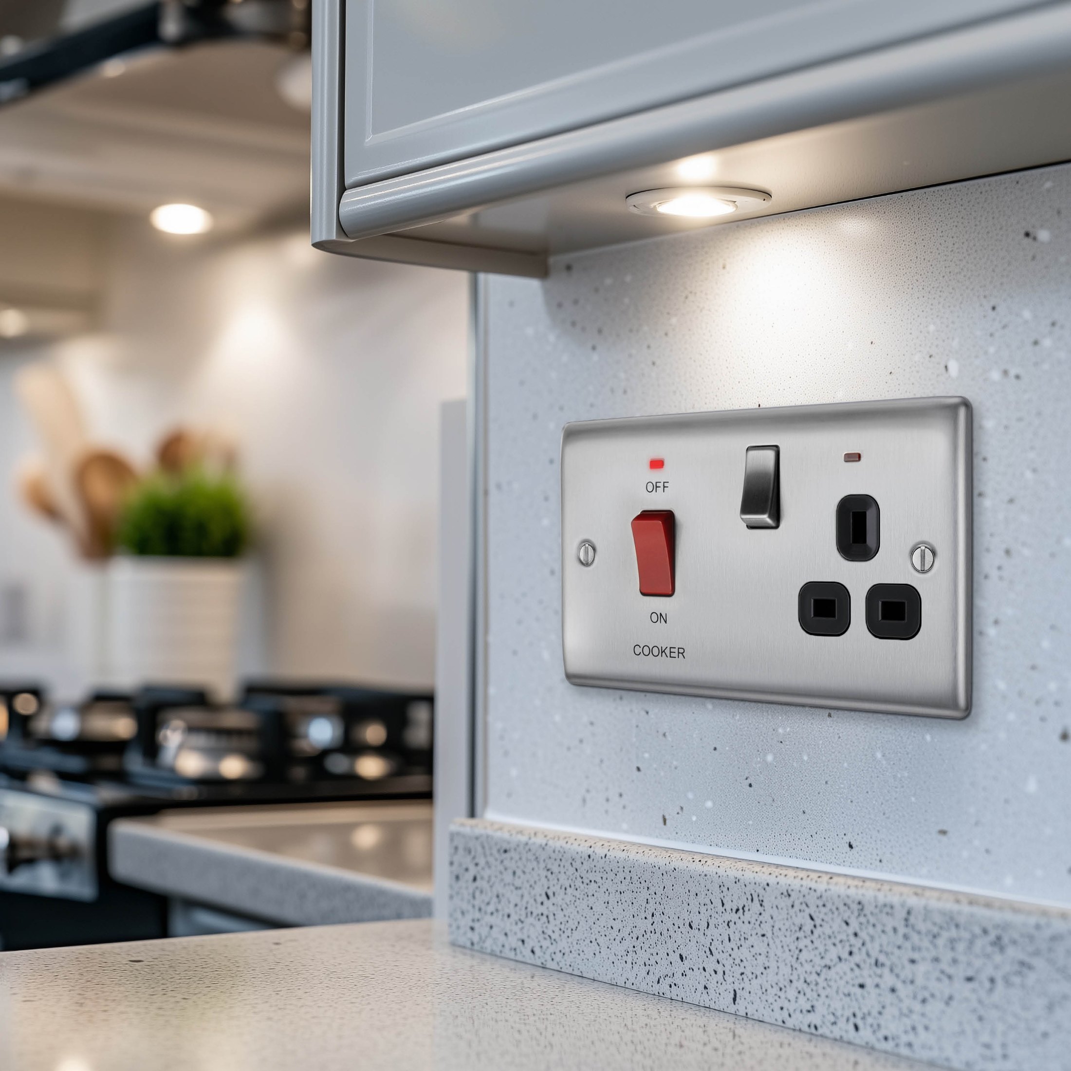 Cooker control switch on a kitchen wall above the worktop