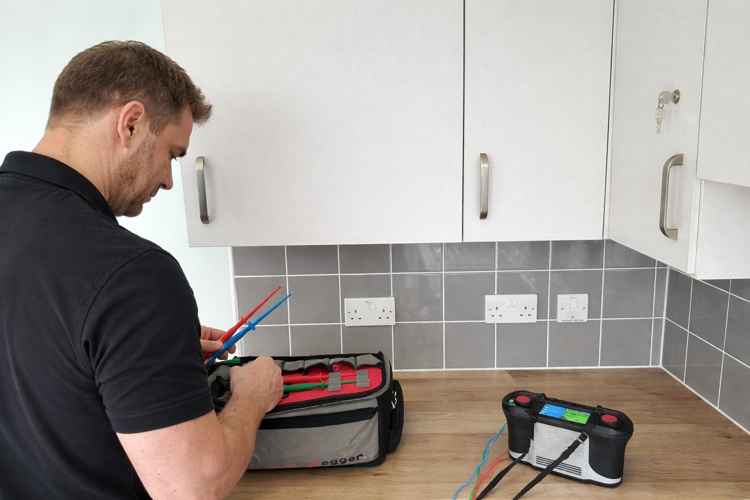 Electrician working methodically at a distribution board