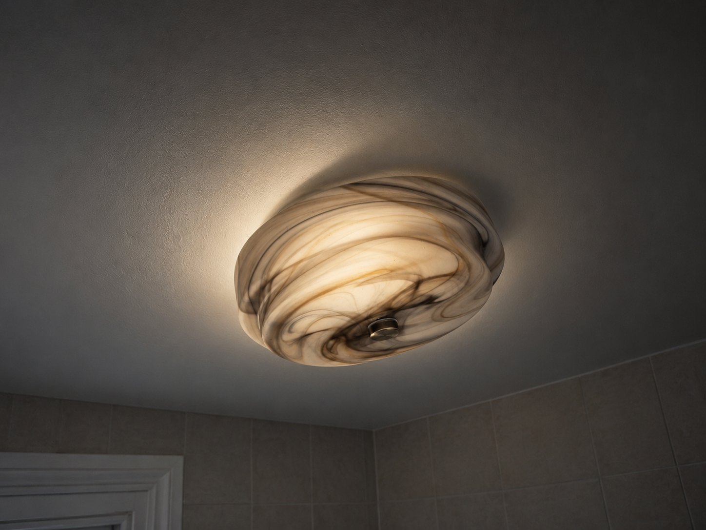 Ceiling light fitting glowing in a bathroom