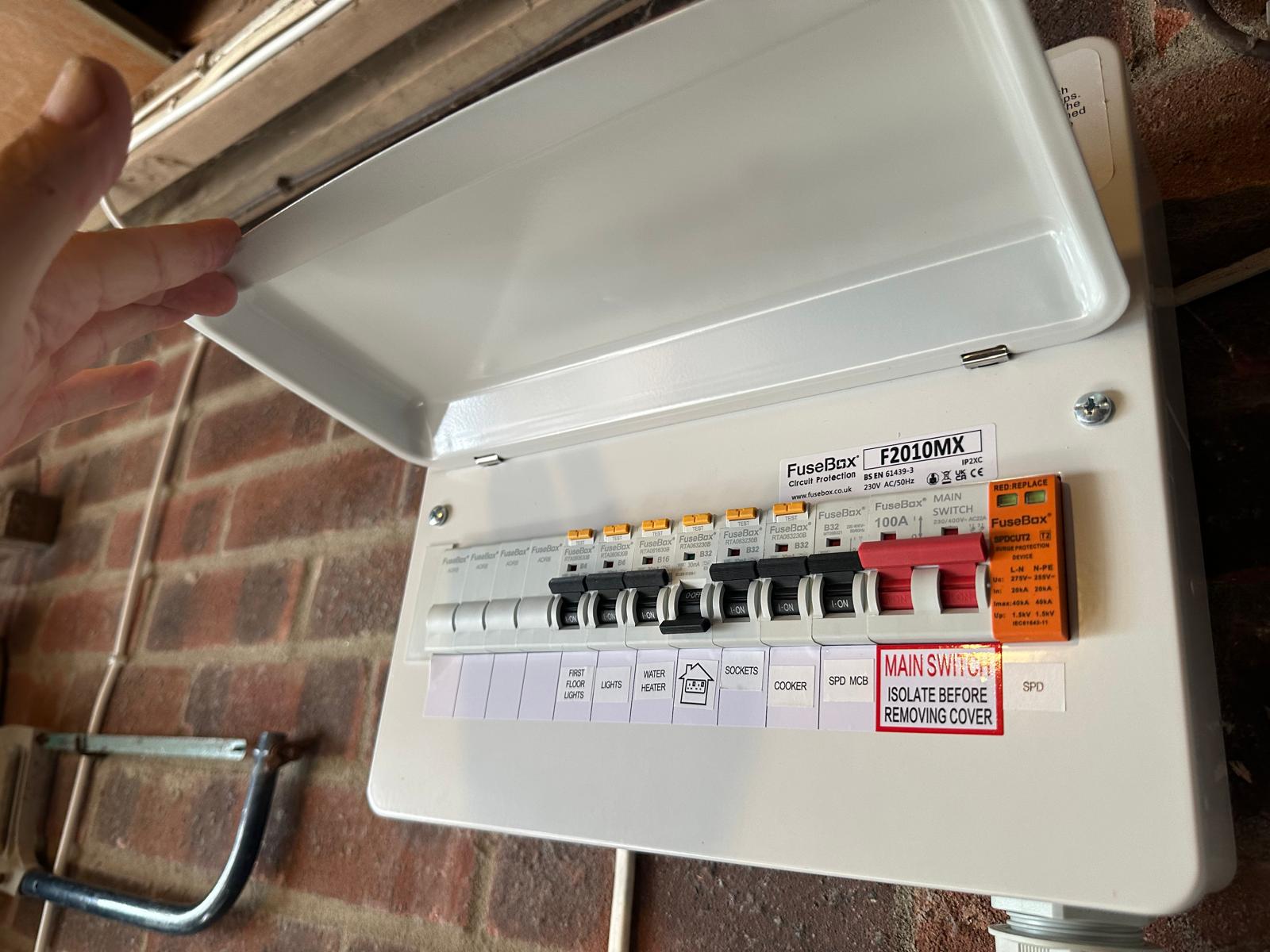 Consumer unit with the cover lifted for inspection